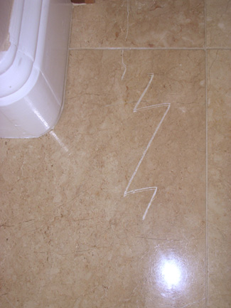 Scratch on marble tile.